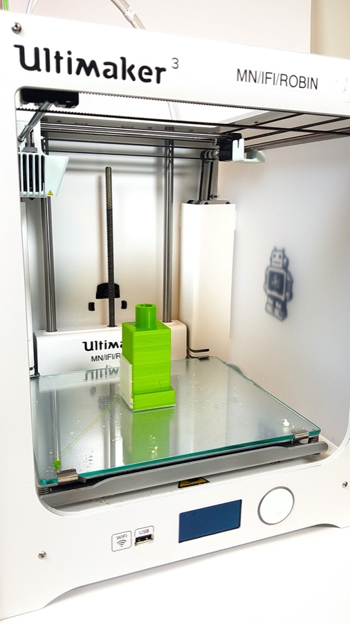 Image of 3d printed part sitting an Ultimaker 3 printer after print completed
